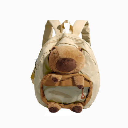 Front view showing accessories inside of beige Cuddly Buddy Backpack