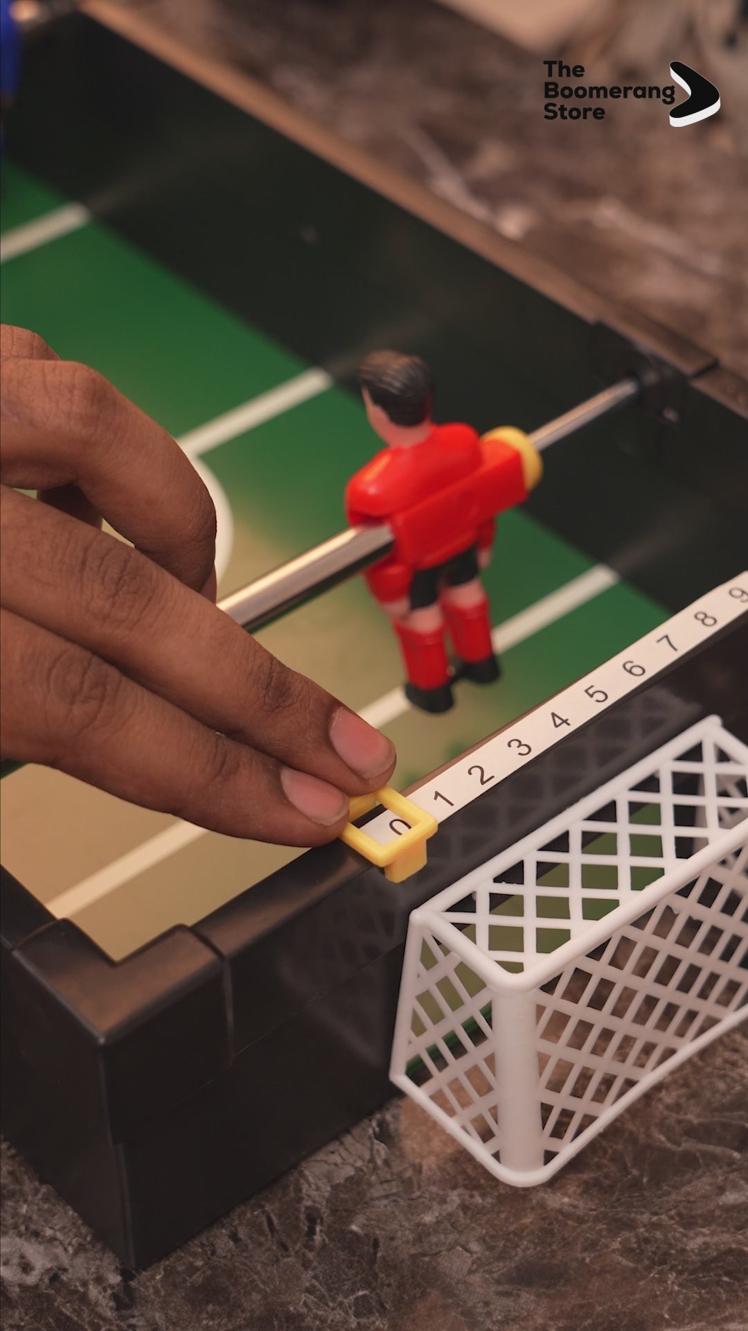 Small foosball drinking game set with player rods and two shot glasses.